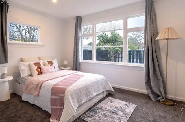 Staged bedroom with pink accents