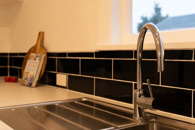 Staged kitchen sink and tapware