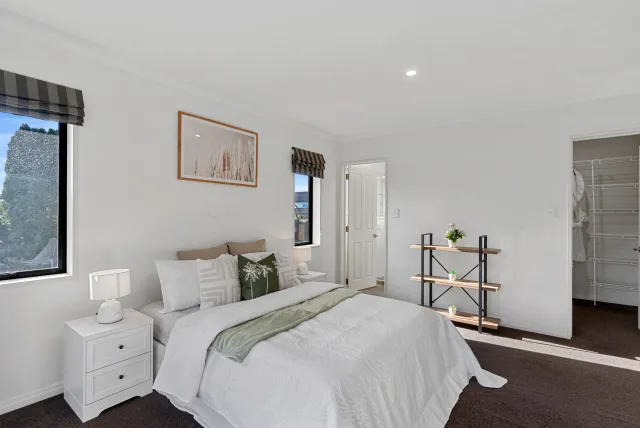 Staged bedroom with green accents