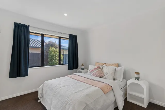 Staged bedroom with peach accents