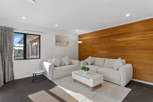 Staged second lounge with timber feature wall