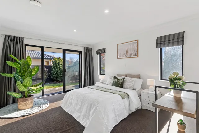 Staged master bedroom with garden outlook
